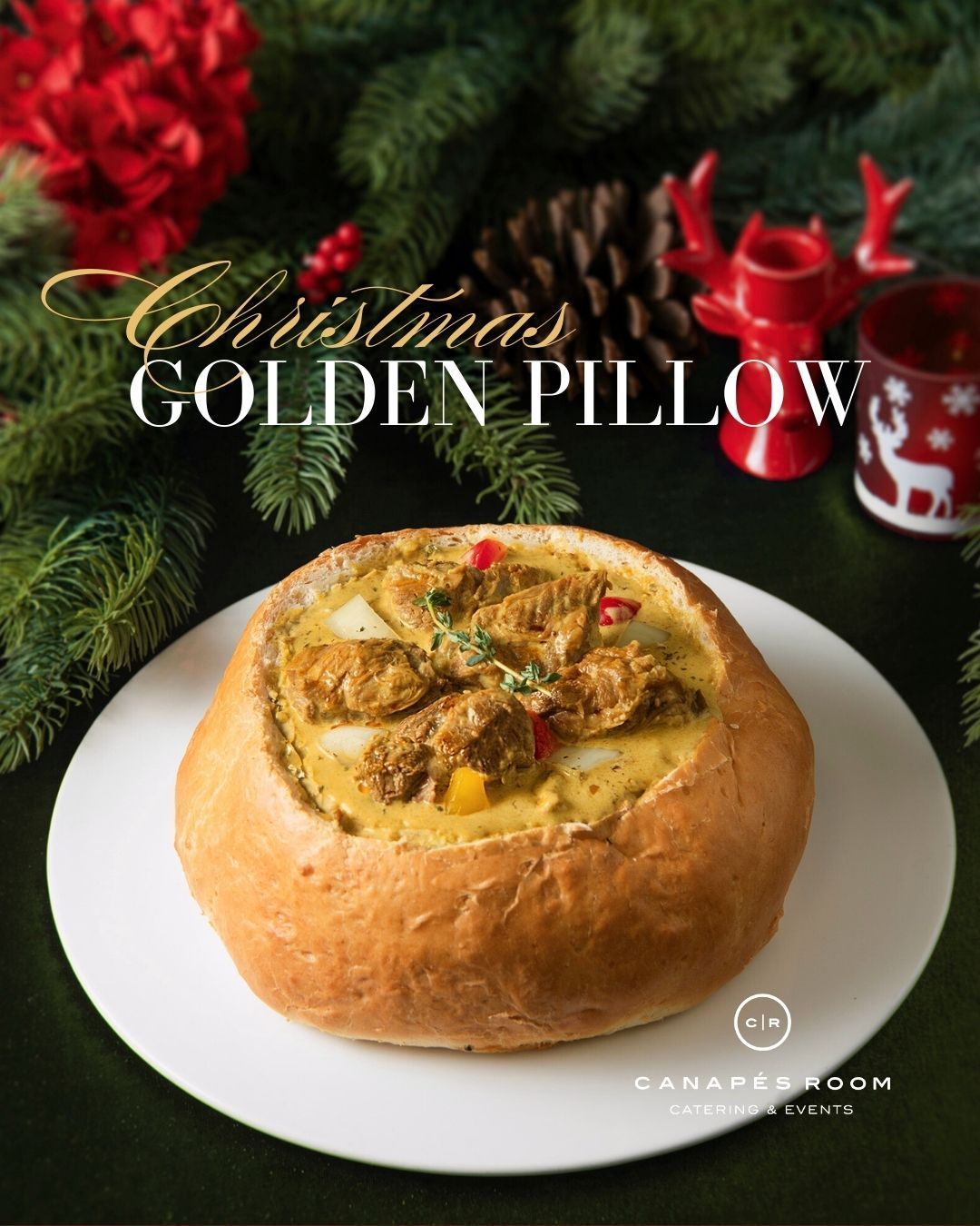 Christmas Golden Pillow dish served in a bread bowl on a white plate, with festive decorations.