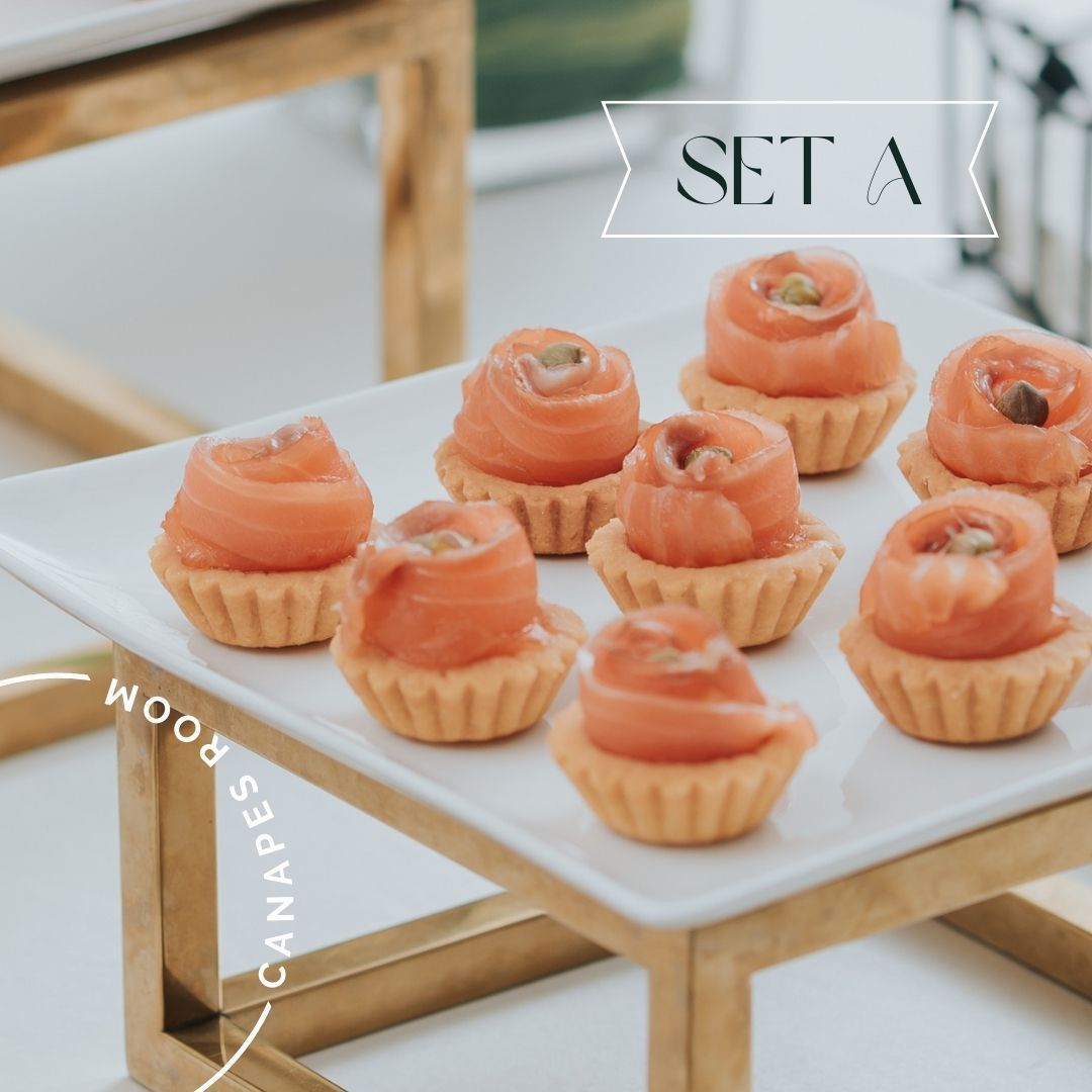 Small salmon appetizers on a white platter, labeled