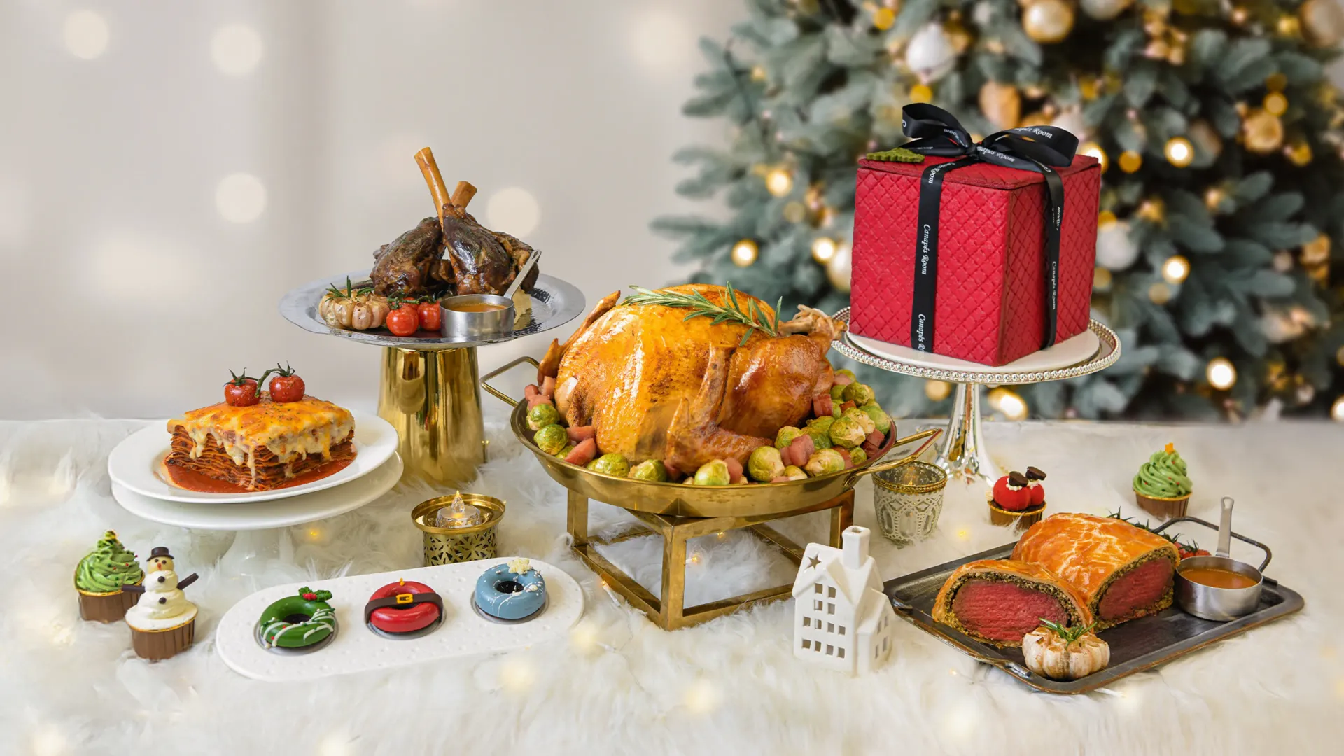Christmas feast: roasted turkey, lamb, cake, side dishes on a table, with Christmas tree in the background.