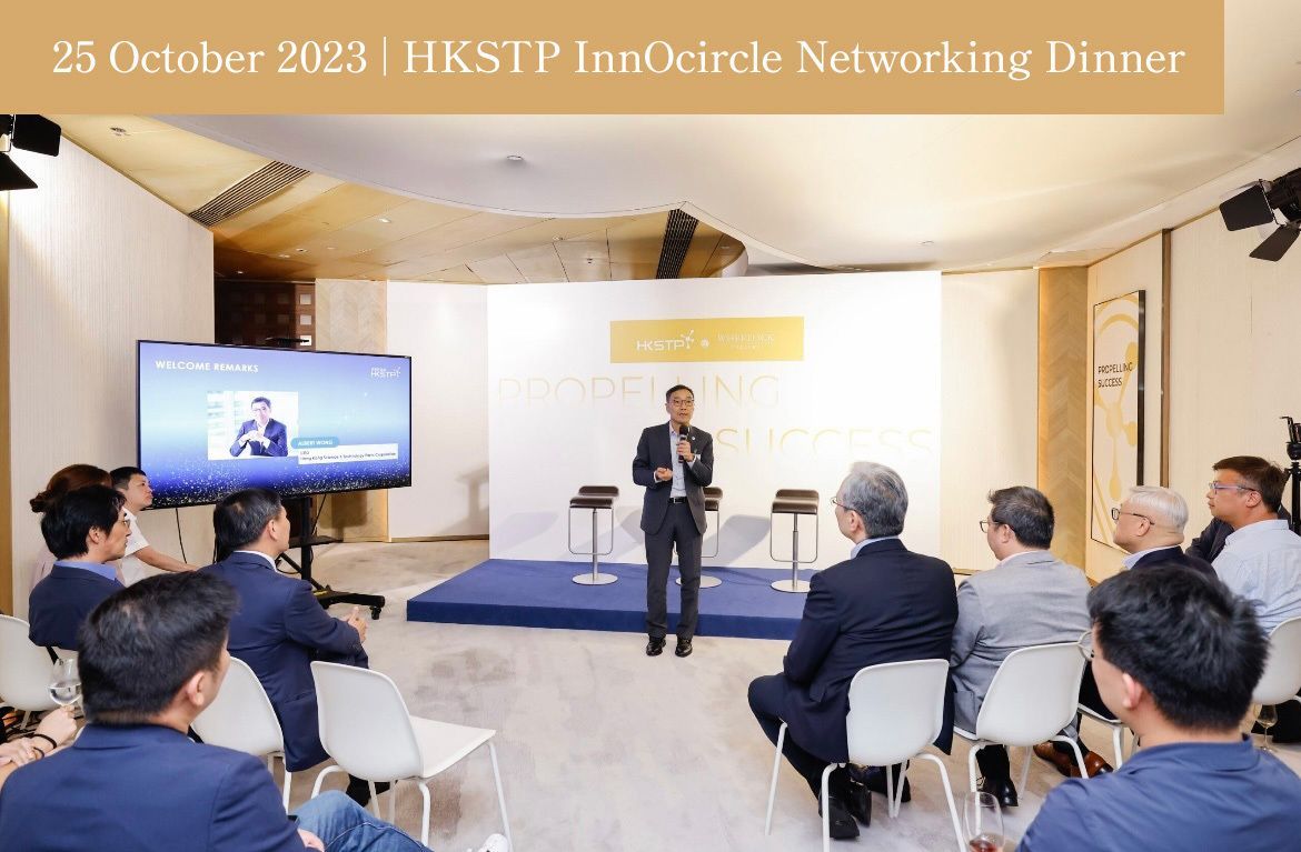 A man speaking at a networking dinner at HKSTP InnOcircle on October 25, 2023. Attendees are seated and listening.