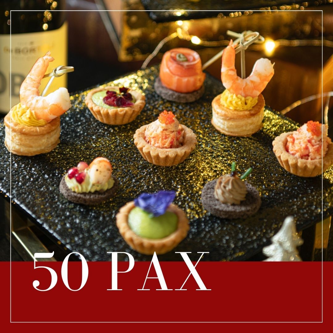 Appetizers on a black tray: shrimp tartlets, smoked salmon rounds, 