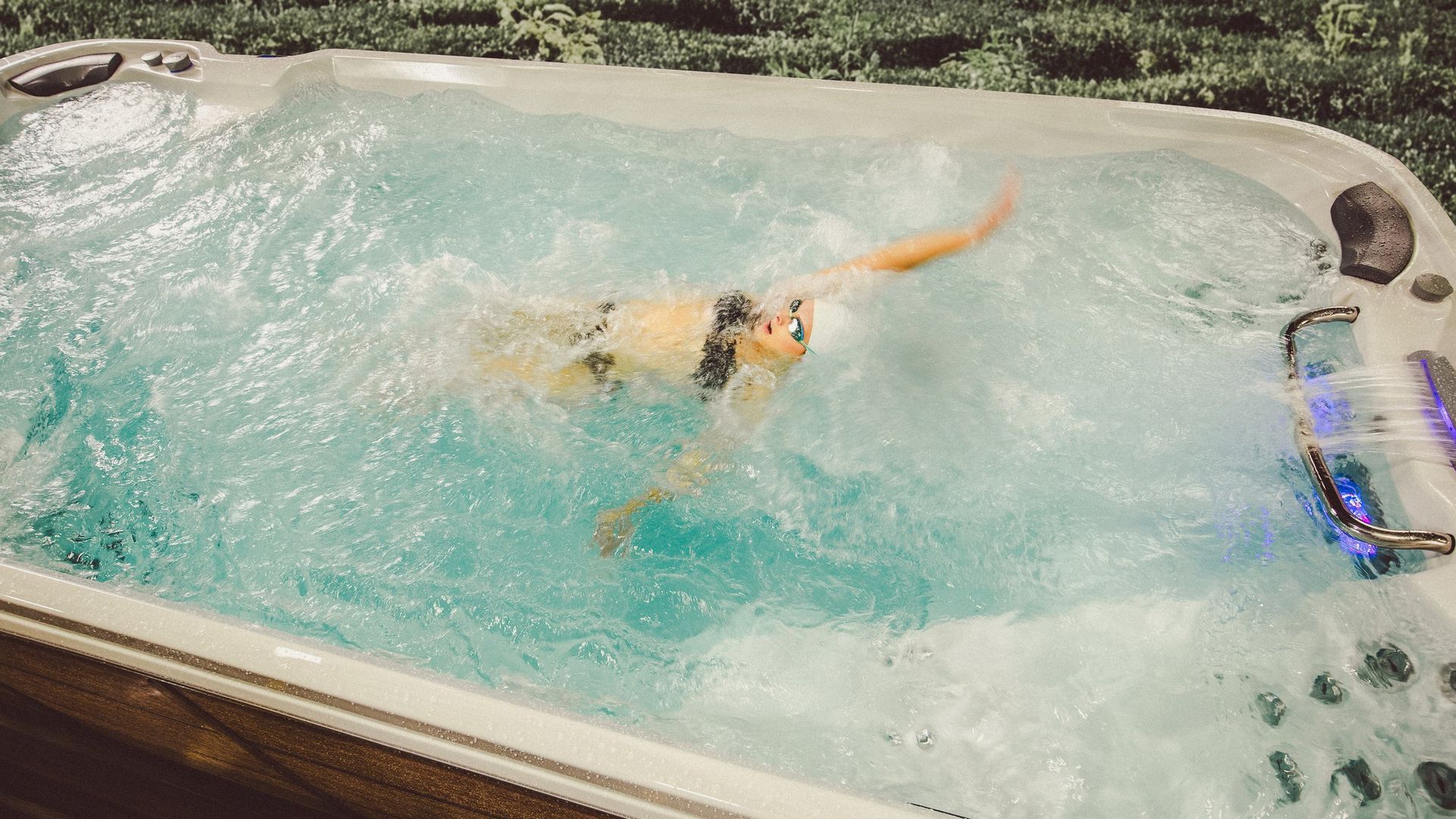 A person is swimming in a hot tub.