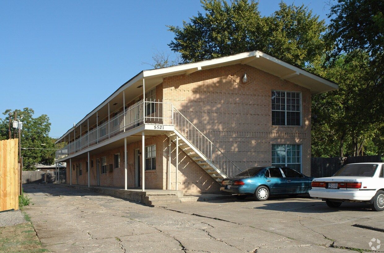 a blue car is parked in front of a building with the number 5351 on it