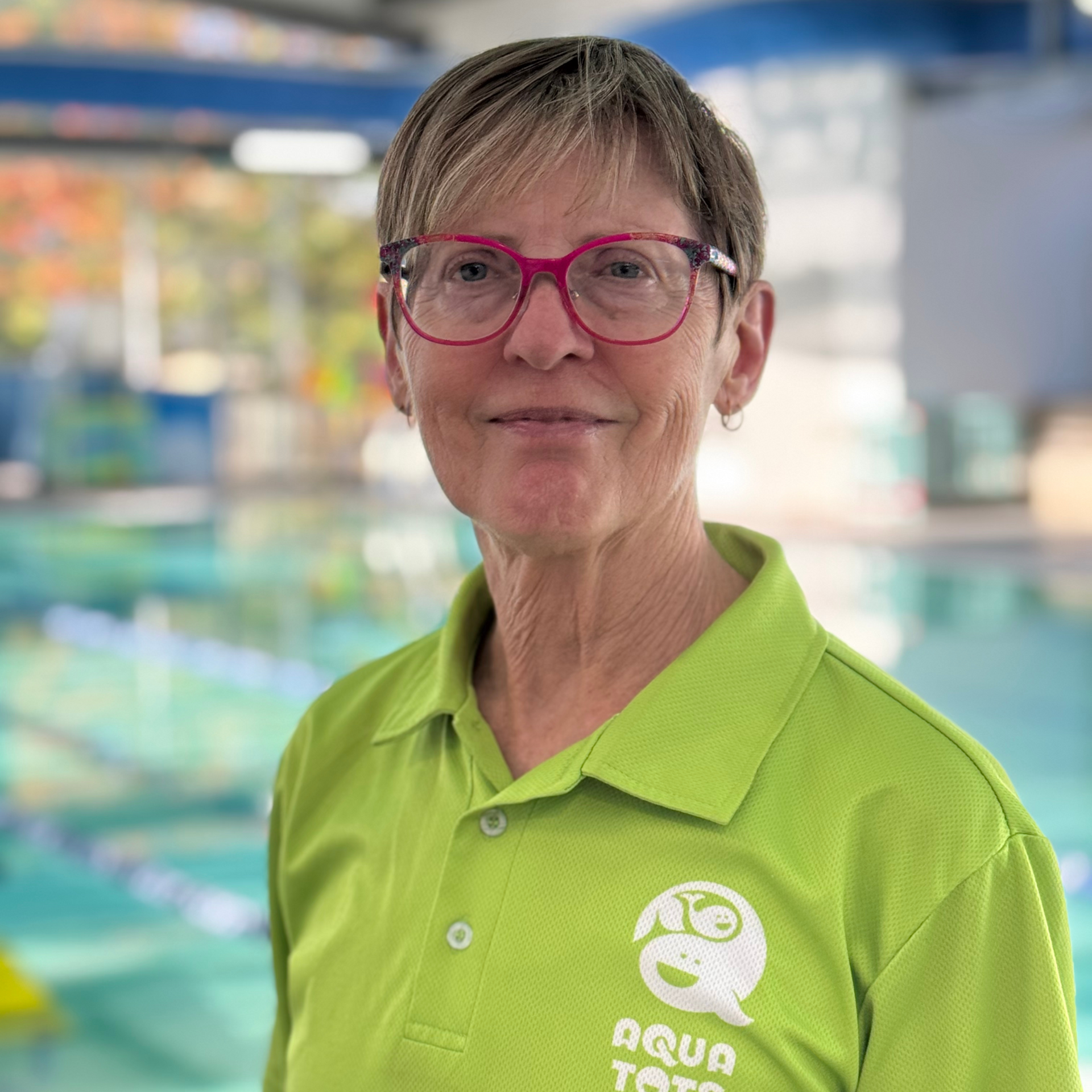 Debbi Sarri wearing glasses and green polo shirt with