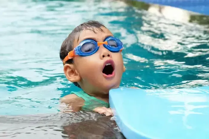 A close up of a child learning how to swim