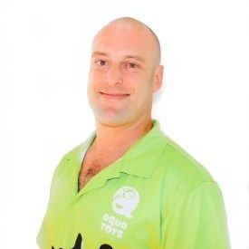 Daniel Sarri with shaved head wearing a green polo shirt smiling, with Aqautots logo