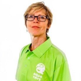 Debbi Sarri wearing glasses and green polo shirt with