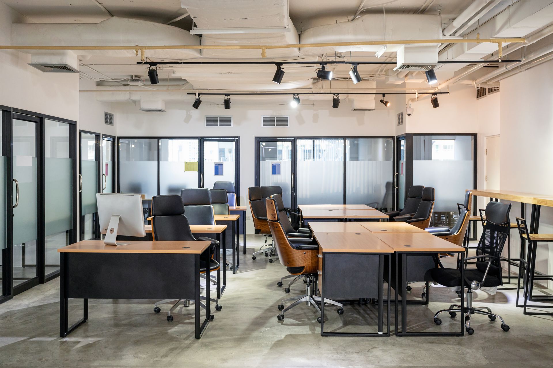 A large office with a lot of desks and chairs.