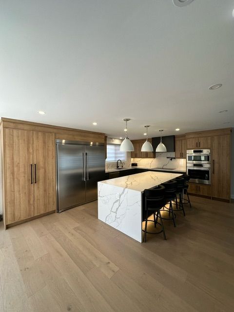 A kitchen with wooden cabinets and stainless steel appliances