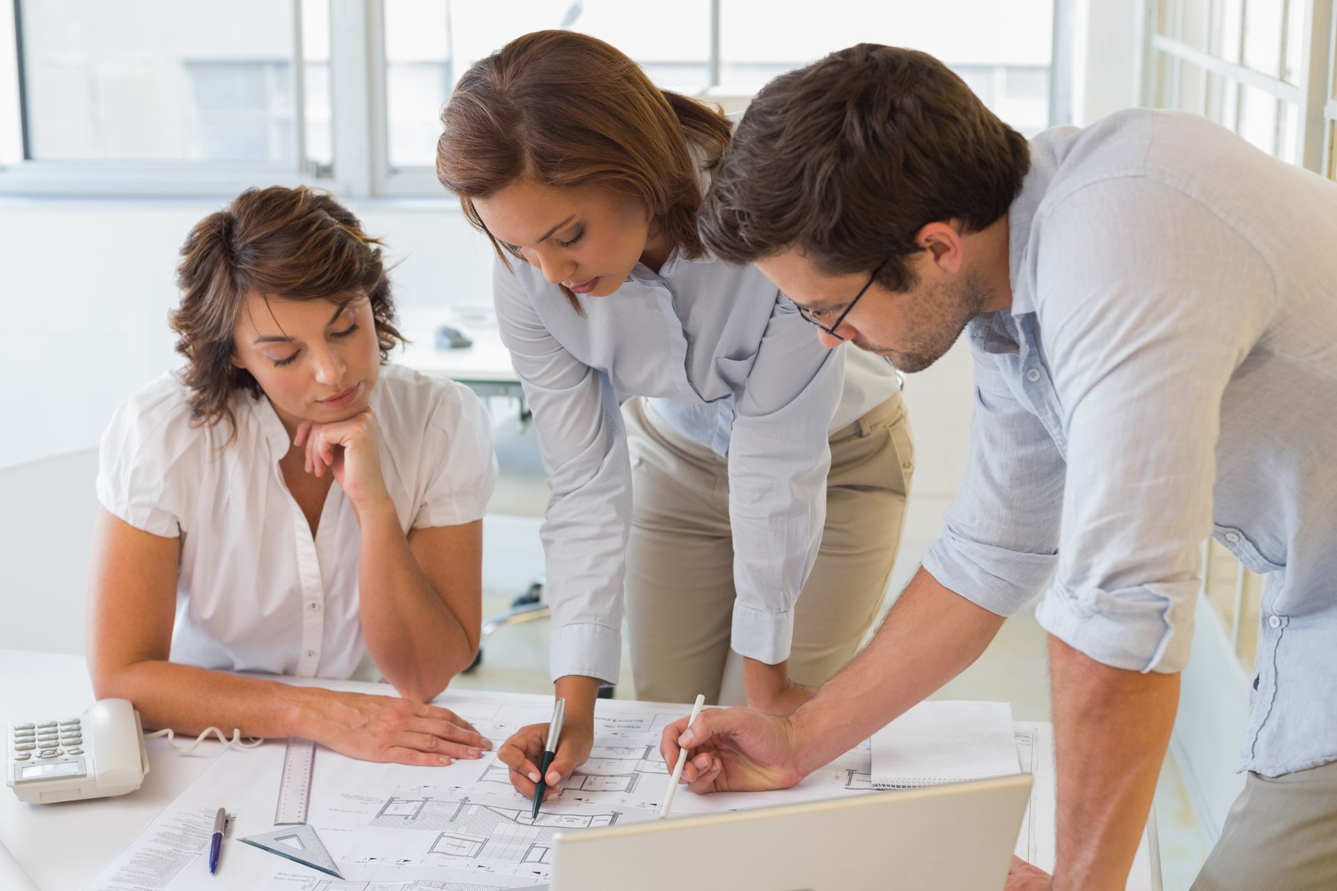 A group of people are looking at a piece of paper.