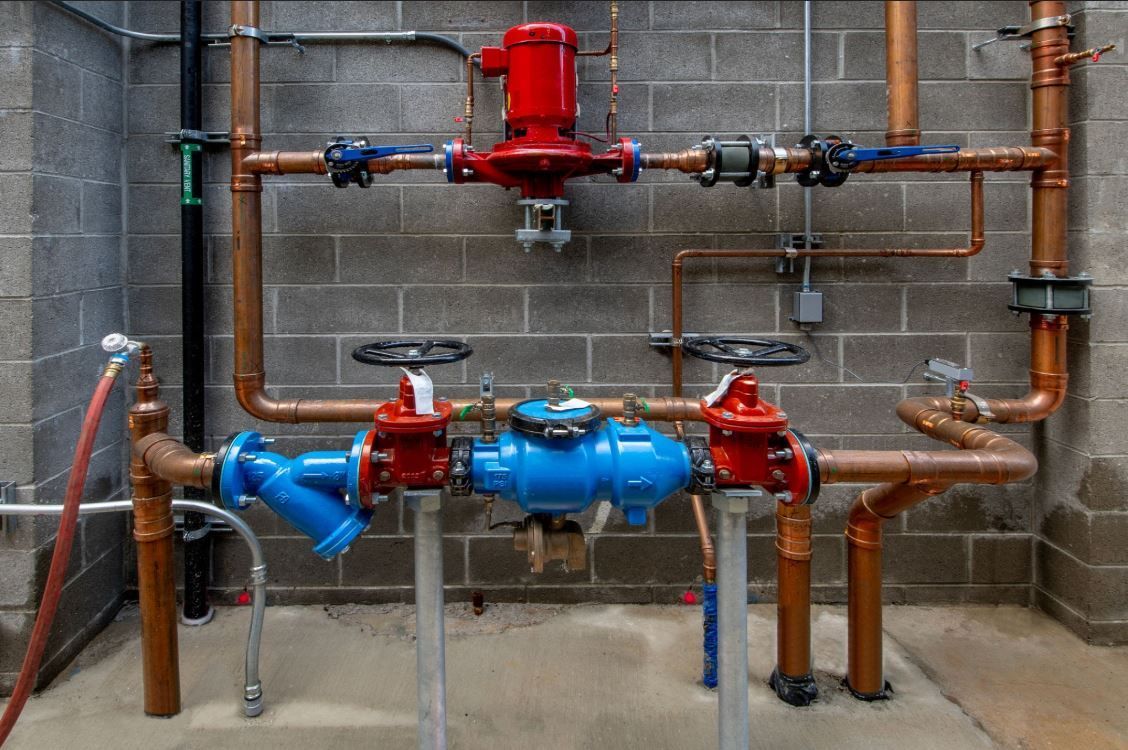Commercial reduced pressure zone RPZ backflow preventer assembly on copper pipes