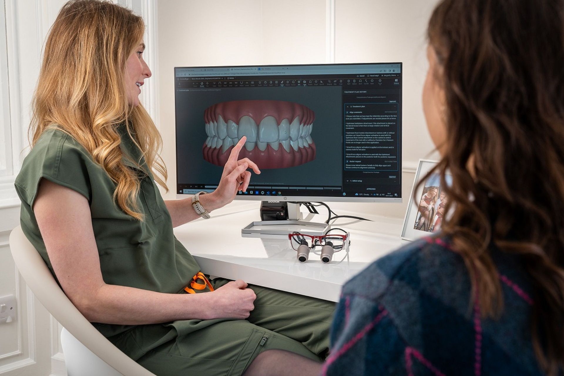 Dentist consulting with a smiling patient during a cosmetic dentistry consultation in Manhattan Beach