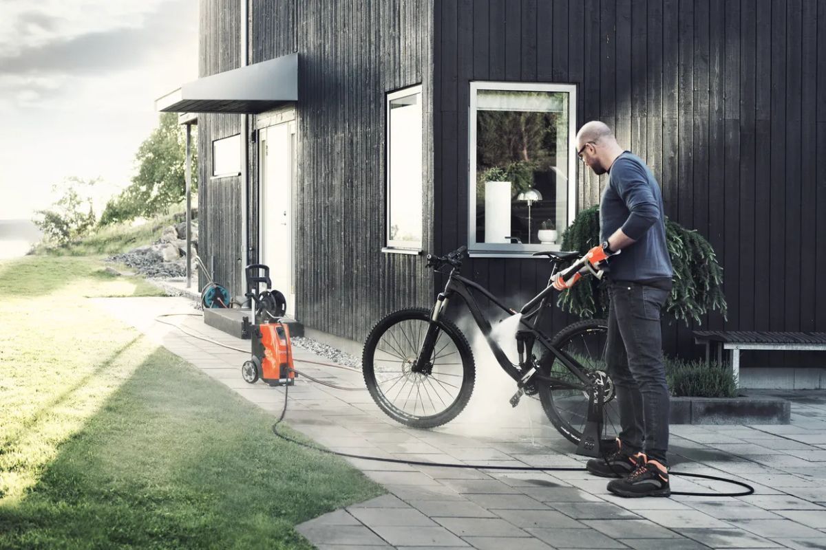 Man Washing a Black Mountain Bike — Tuggerah Outdoor Power in Tuggerah, NSW