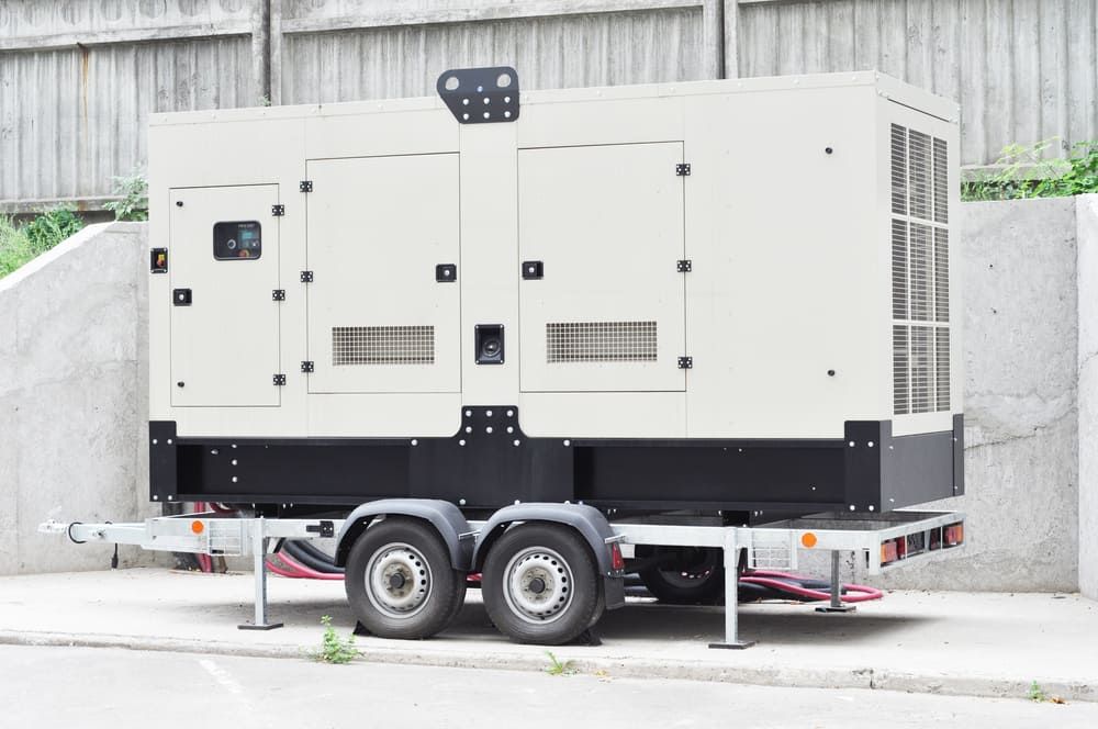 A Large, Light Beige, Industrial Power Generator Mounted on a Flatbed Trailer — Tuggerah Outdoor Power in Tuggerah, NSW