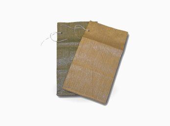 Two military specification polypropylene burlap sandbags.