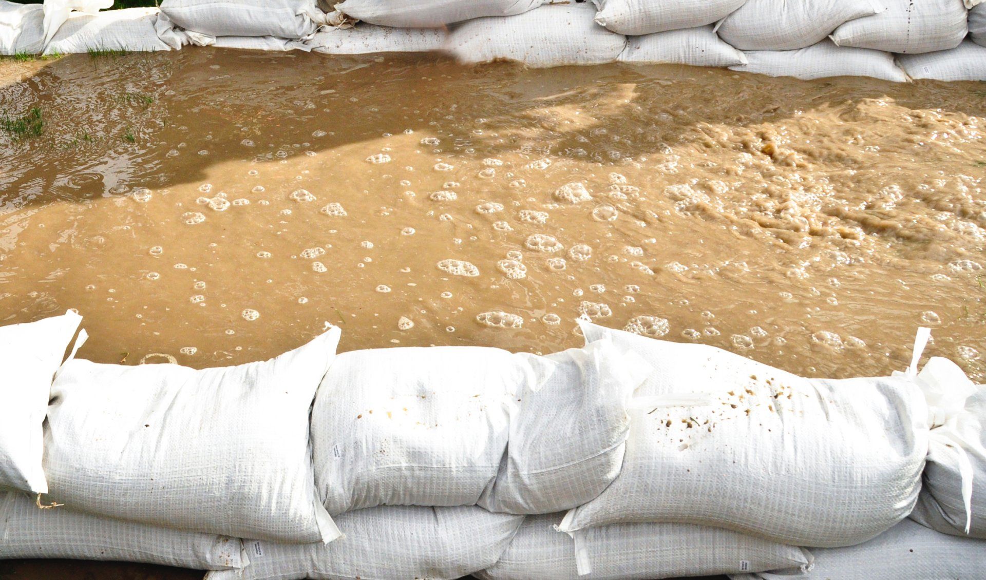 Sandbags blocking flood water from moving.