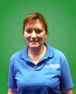 Tracy Watson, smiling in a blue shirt.