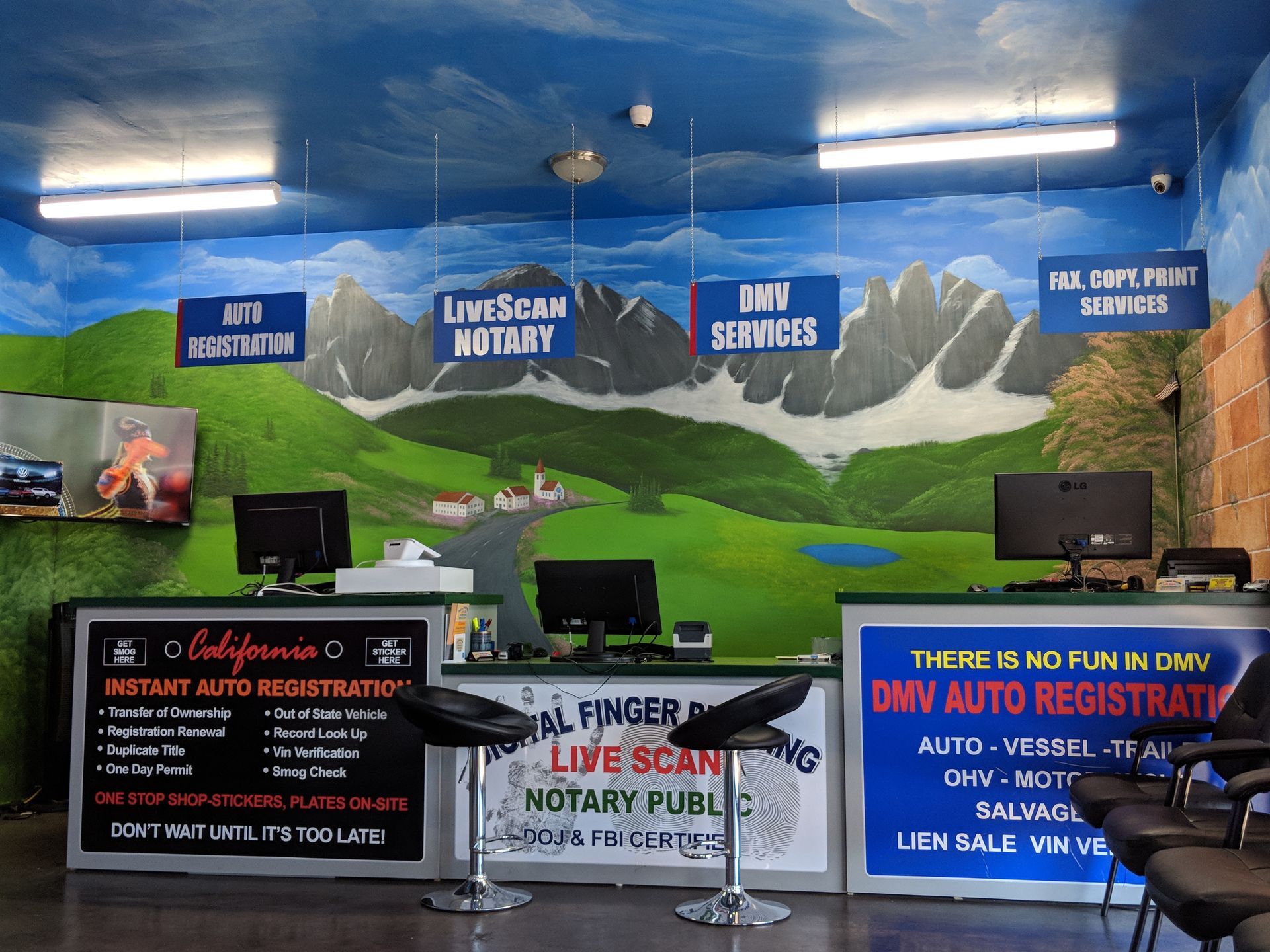 Blue interior with mountain mural, DMV services signs, and auto registration counters