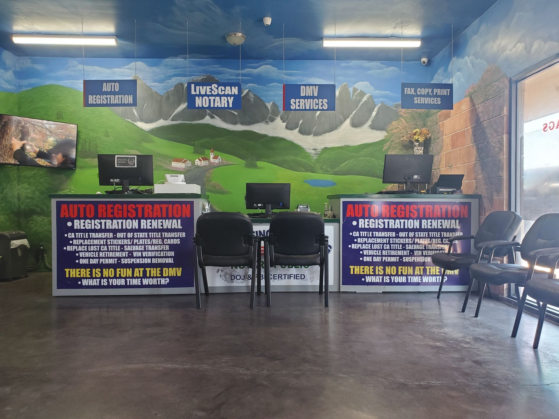 Interior of a mobile event booth with blue mountain backdrop, chairs, and promotional signs about food safety.
