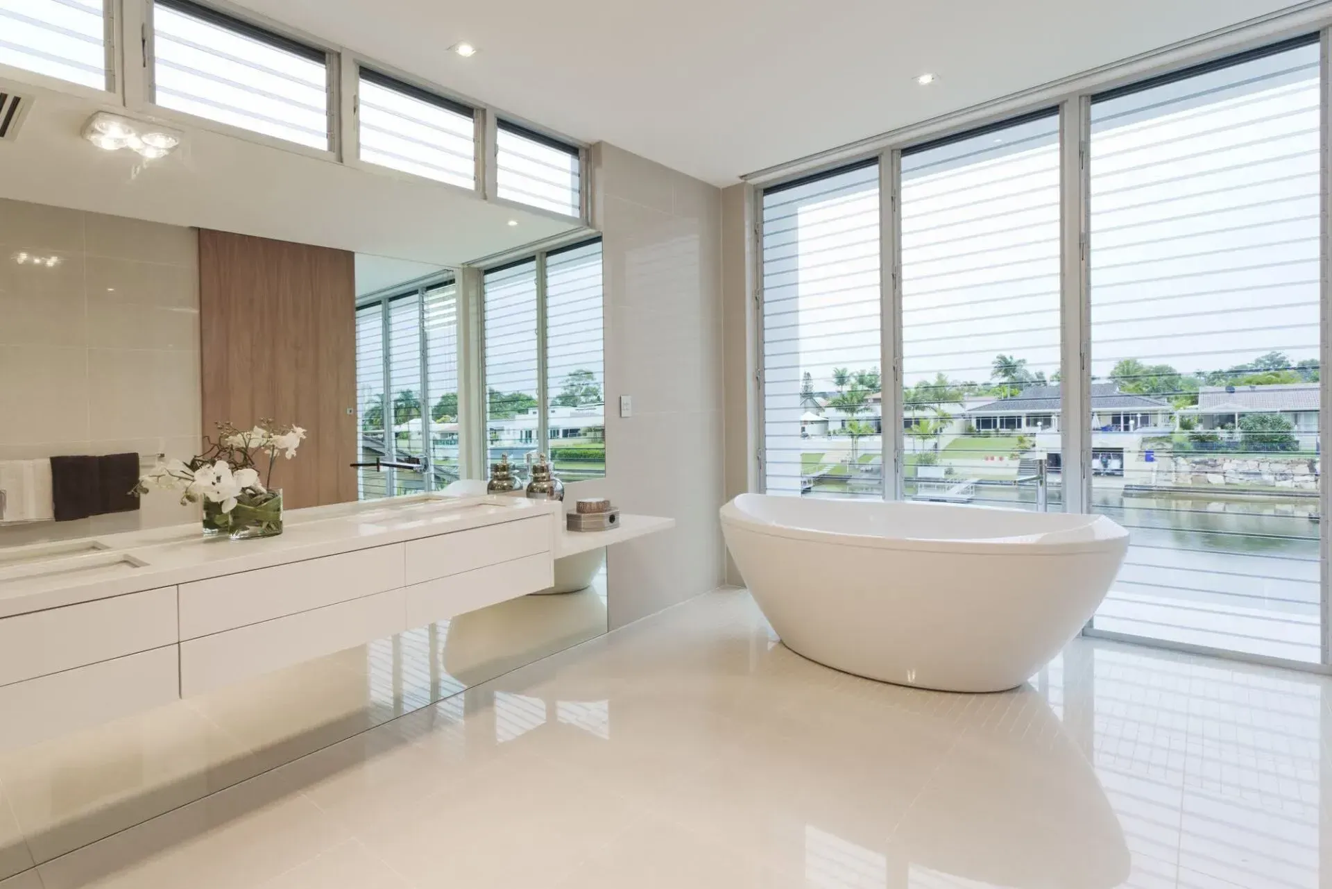 A bathroom with a large tub and lots of windows