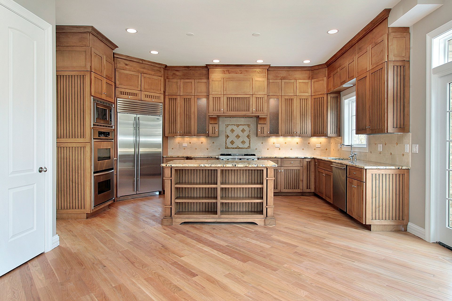 A kitchen with wooden cabinets and stainless steel appliances