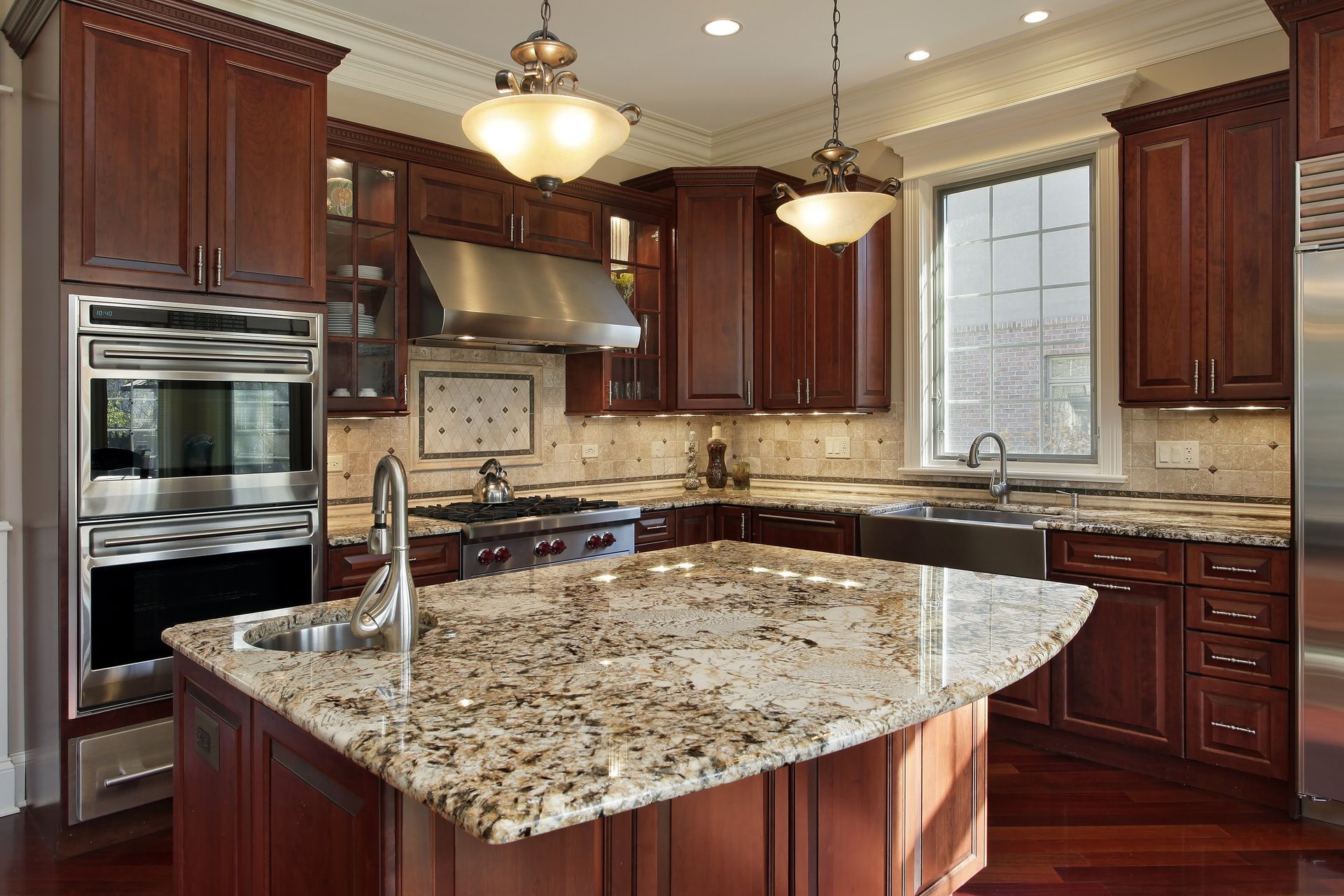 A kitchen with granite counter tops and wooden cabinets