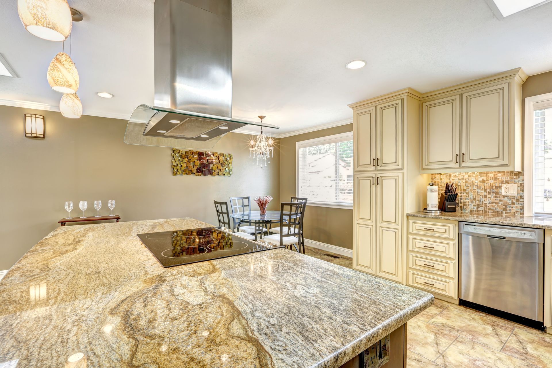 A kitchen with granite counter tops and stainless steel appliances.