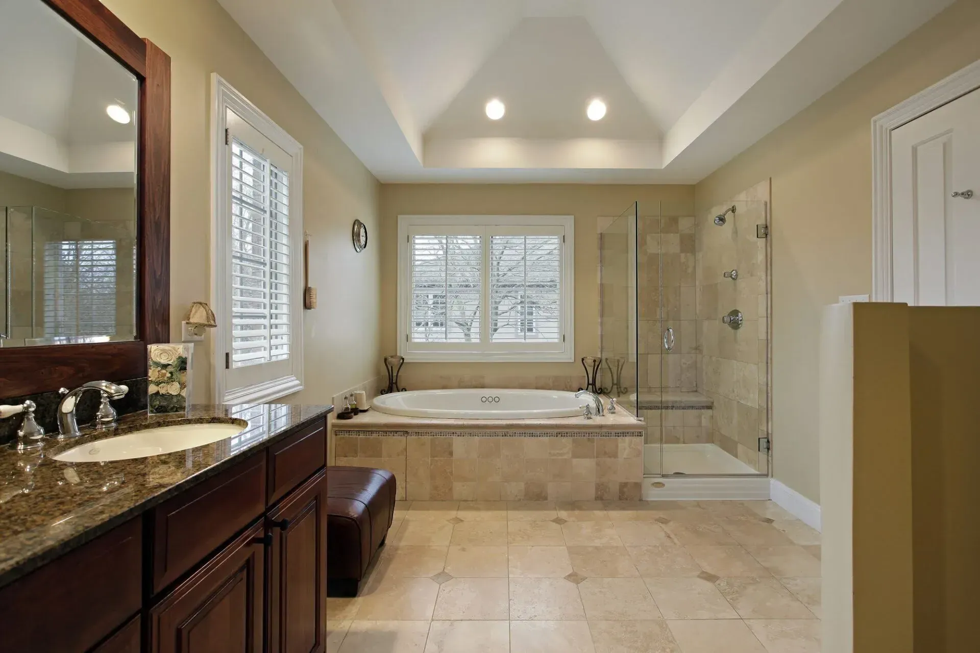 A bathroom with a jacuzzi tub and a walk in shower