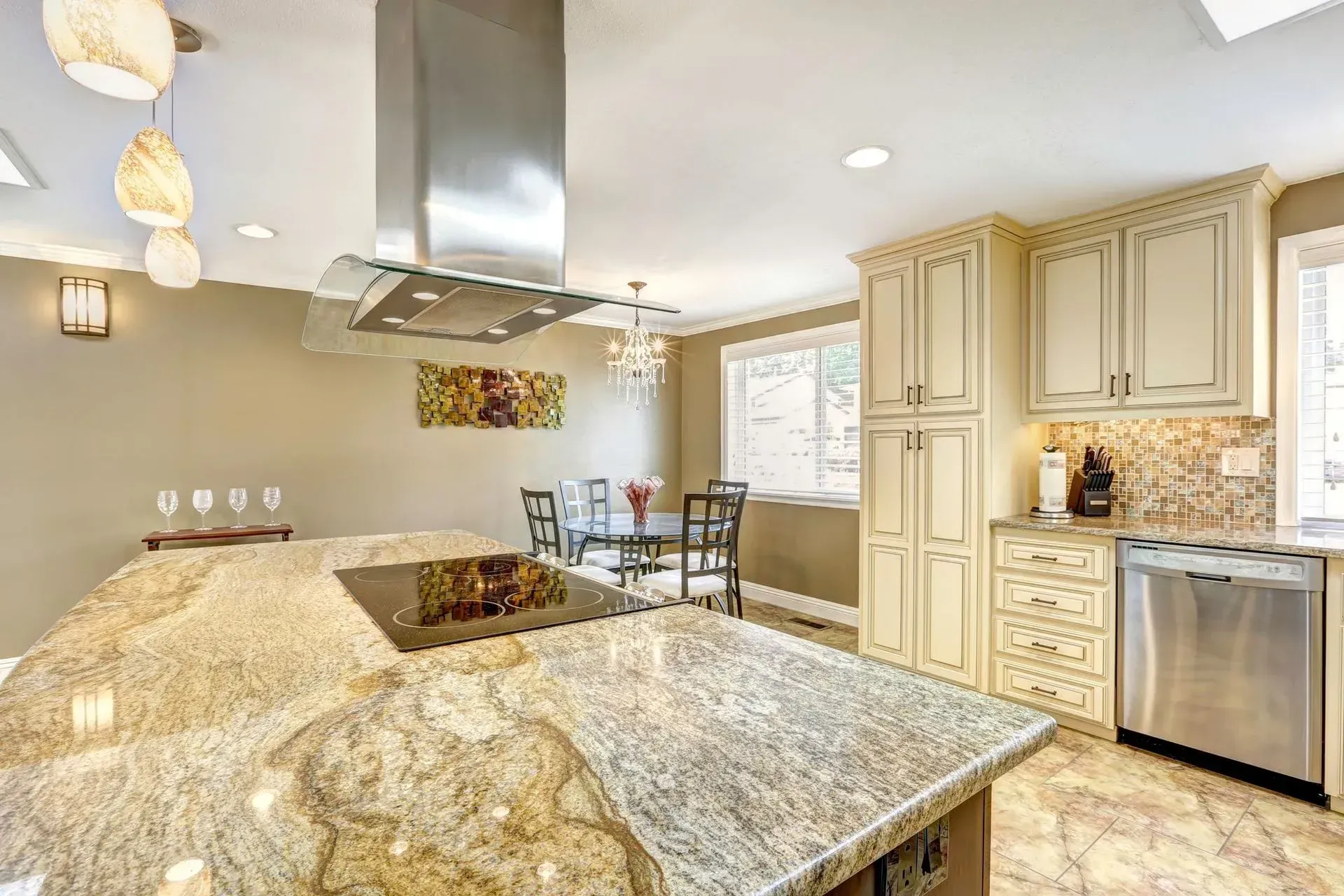 A kitchen with granite counter tops and stainless steel appliances.