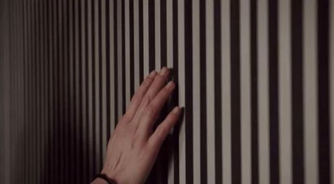Physically checking the wall for eavesdropping devices.