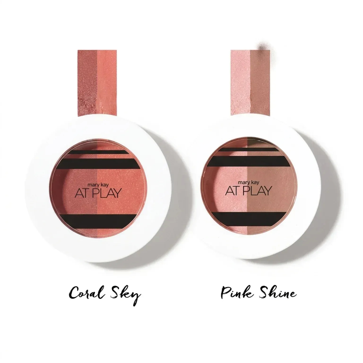 Dos muestras de cosméticos etiquetadas como Coral Sky y Pink Shine, presentadas en estuches redondos blancos.