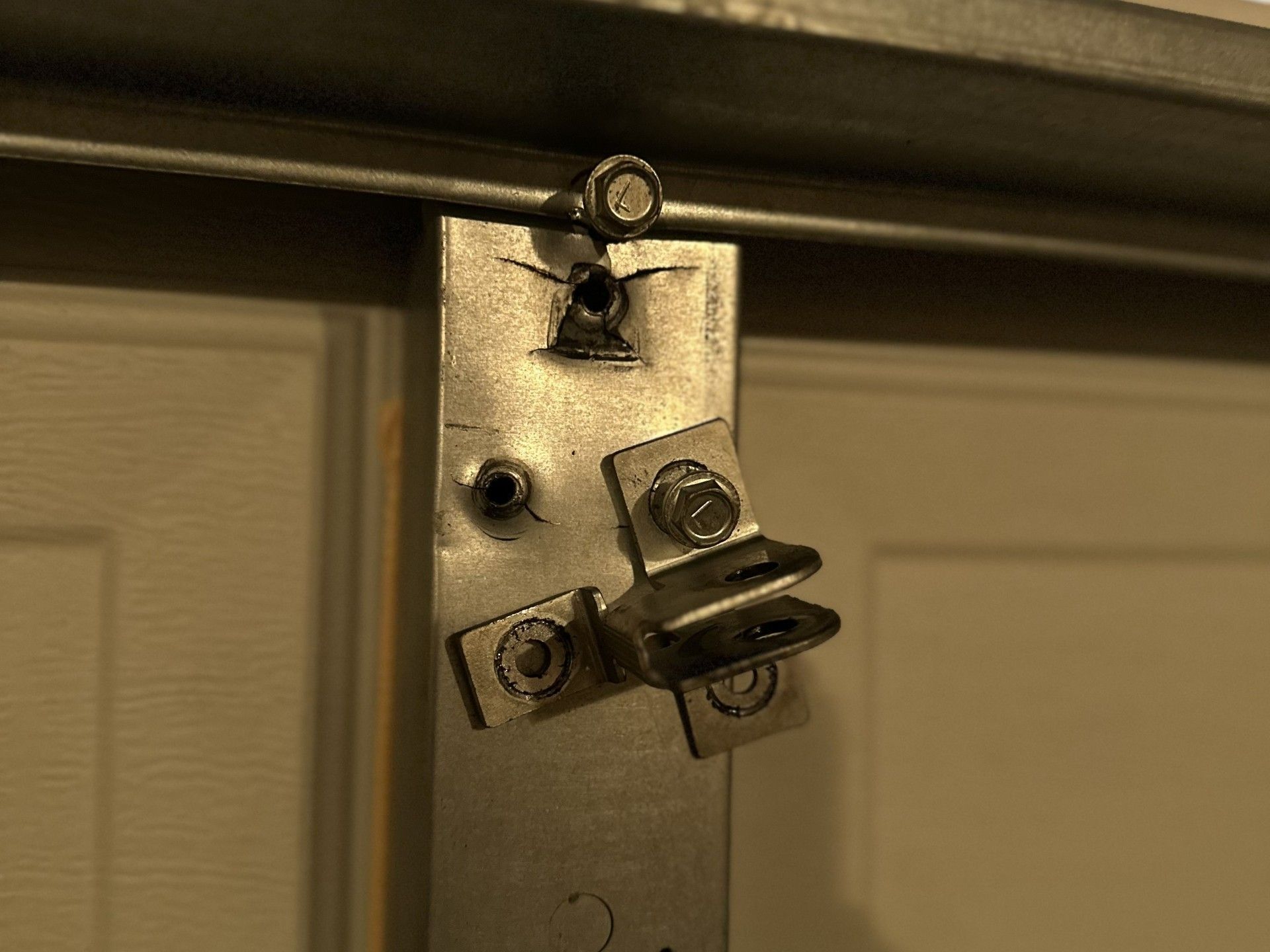 A close up of a metal bracket on a garage door.