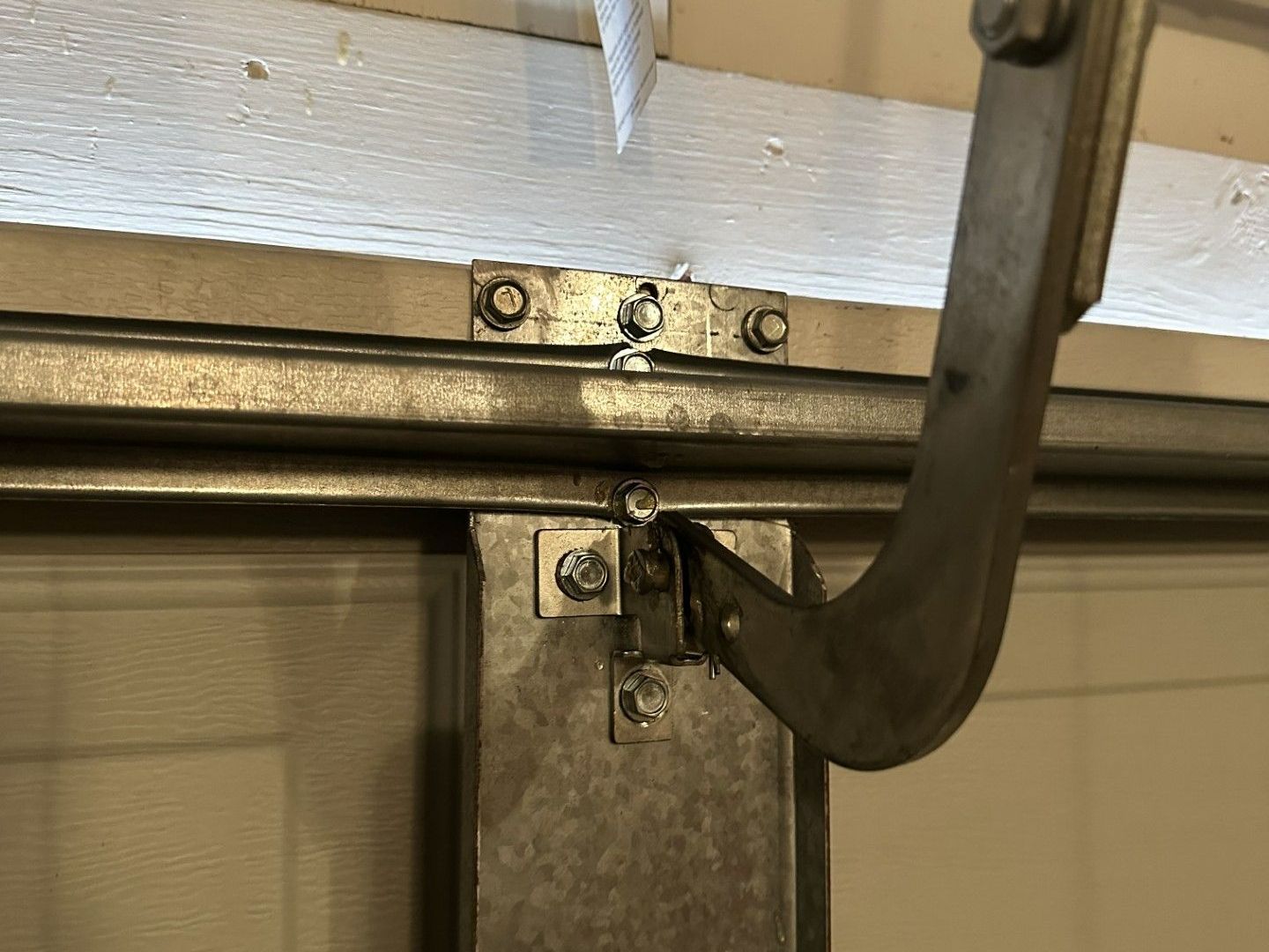 A close up of a garage door with a hook attached to it.