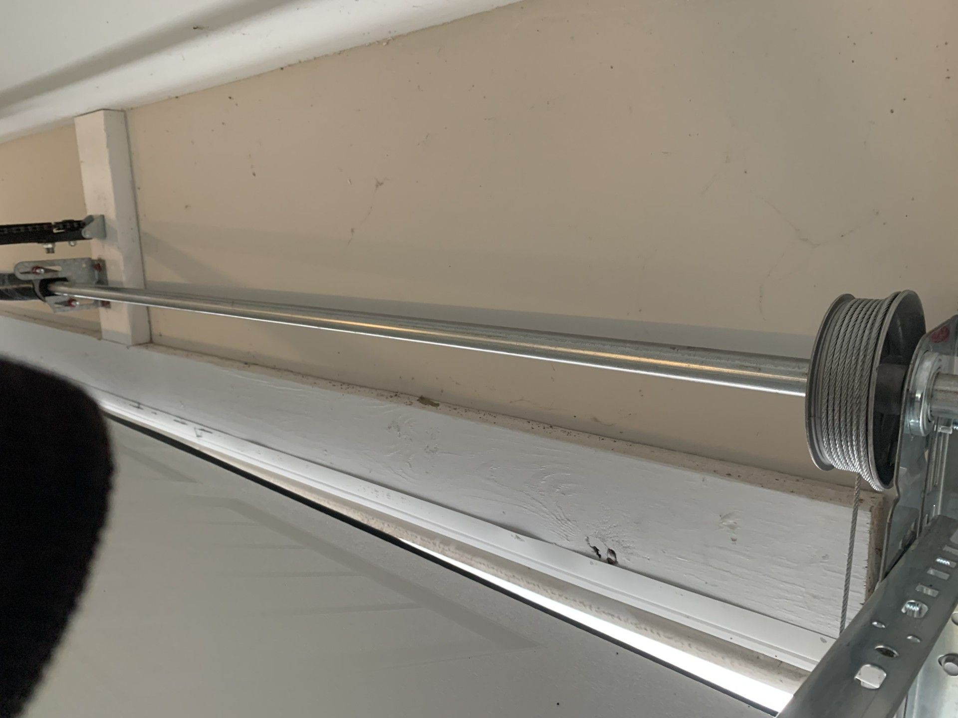A close up of a garage door with a hook attached to it.