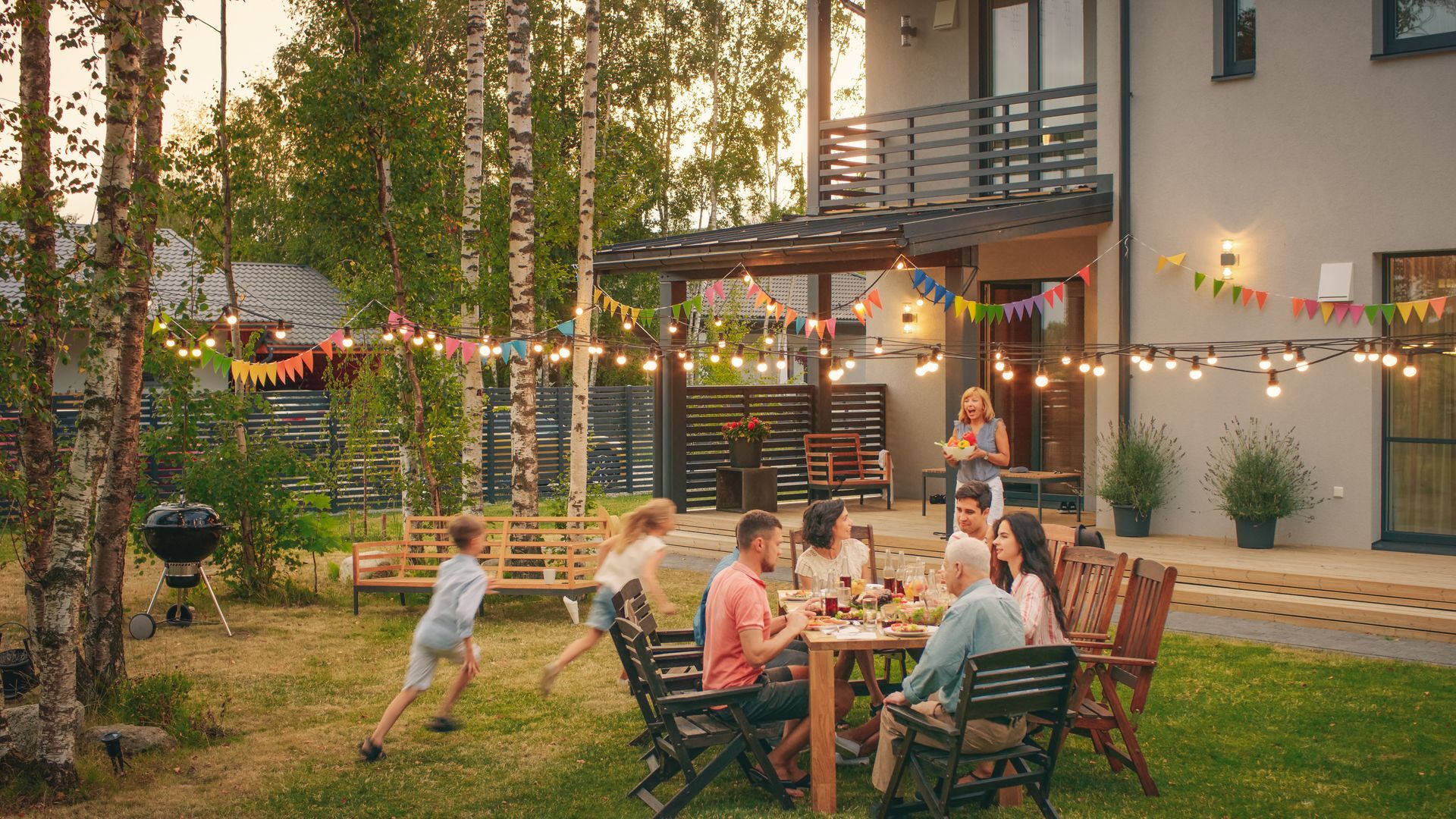 A family is having a dinner party in their backyard.