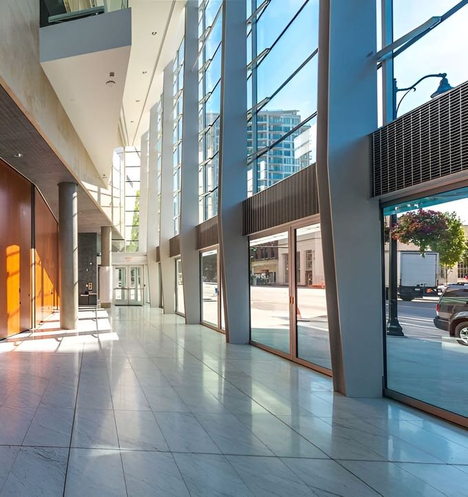 A Hallway In A Building With A Lot Of Glass Windows — GGS Alice Glass & Aluminium In Ciccone, NT