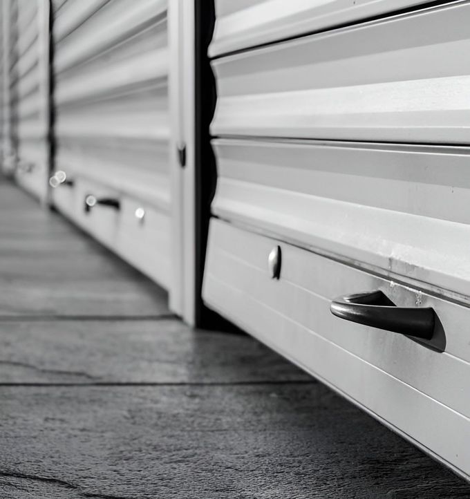 A Black And White Photo Of A Row Of Garage Doors — GGS Alice Glass & Aluminium In Ciccone, NT
