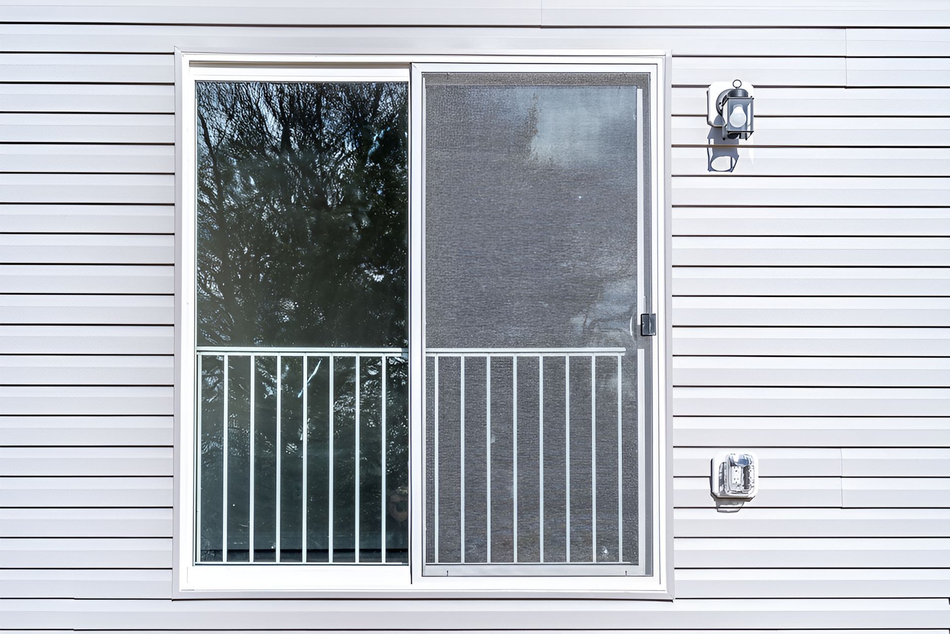 A Sliding Patio Door on a Vinyl Siding Wall Features Built-in Security Screens