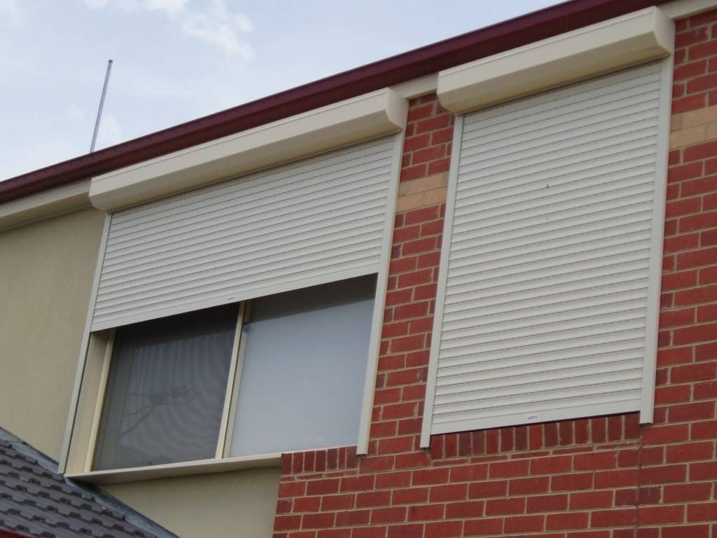 Bricked House with White Roller Shutters