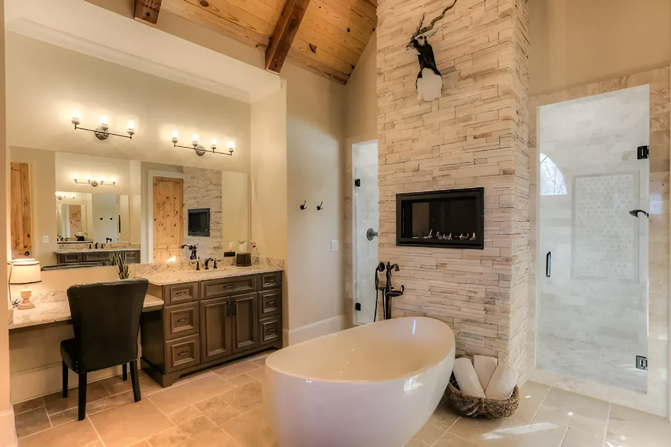 Spacious luxury bathroom with freestanding tub, vanity, walk-in shower, fireplace, and vaulted wood ceiling