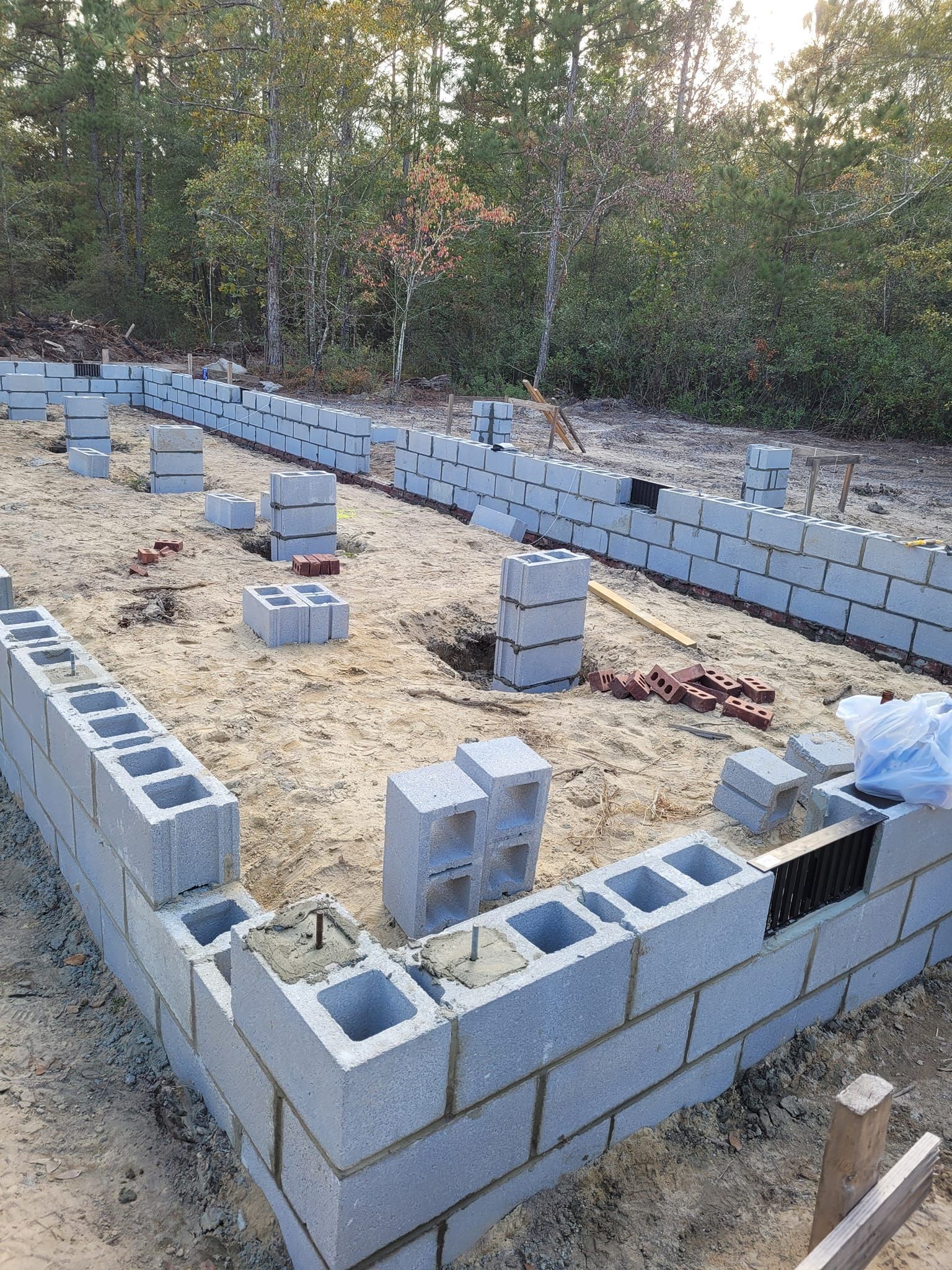 A Row of Concrete Blocks Sitting on Top of a Dirt Field.