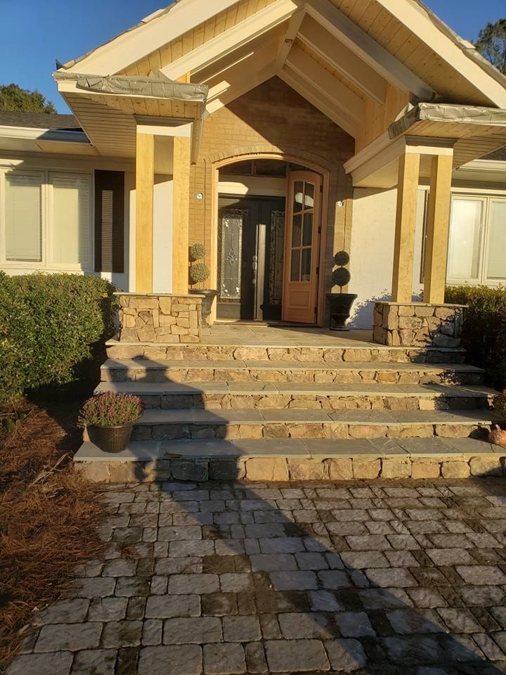 The front of a house is installed with pavers.