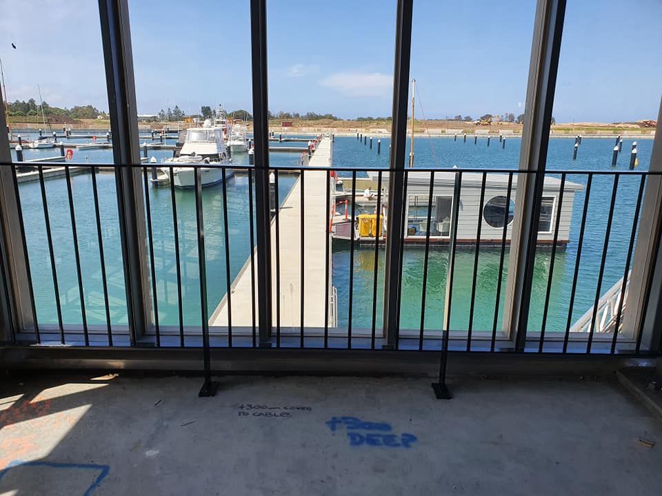 A House With a Balcony and Black Fencing— D & T Balustrade Systems In Bulli, NSW