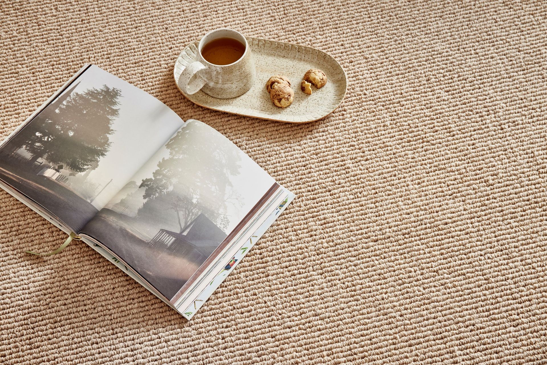 Rolled-up carpets of various colours and patterns on display, likely in a store setting.