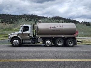 A tan water truck with 