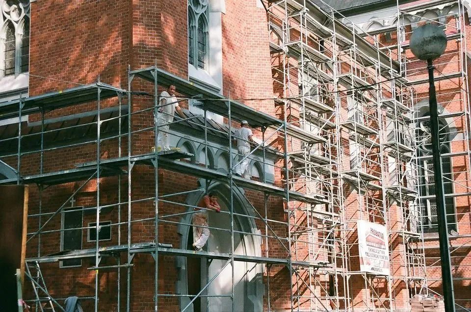 Construction Workers in a Trestle Scaffolding