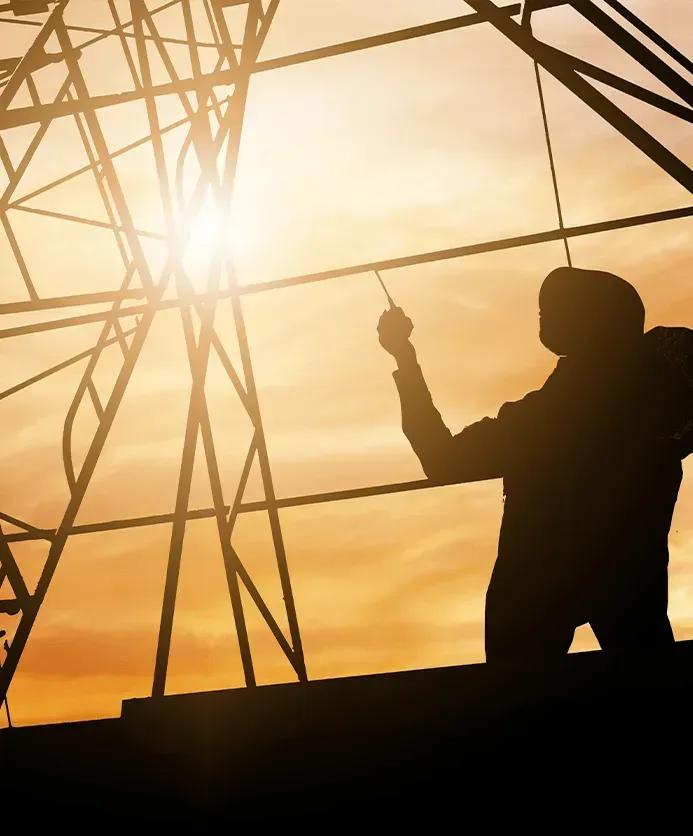 silhouette of a worker standing on the scaffolding