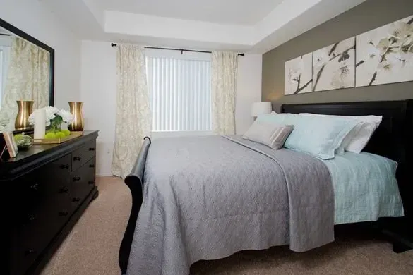 photo showing a bedroom with a medium to large size window