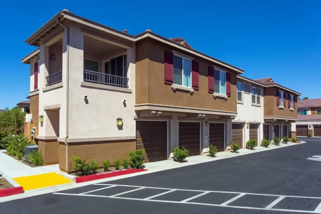 photo showing the community and garages below the apartments