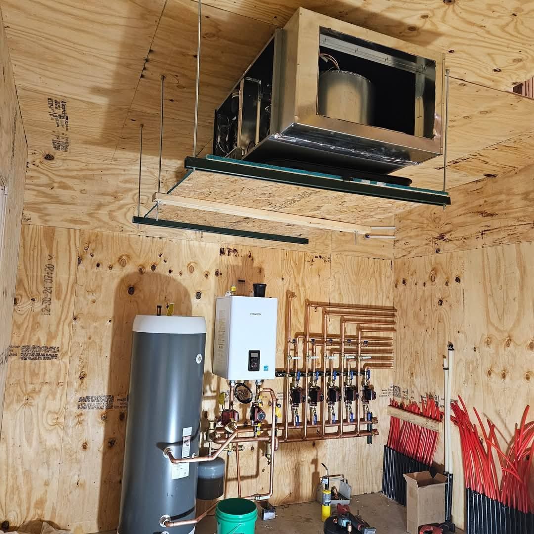 A room with a water heater and a ceiling fan